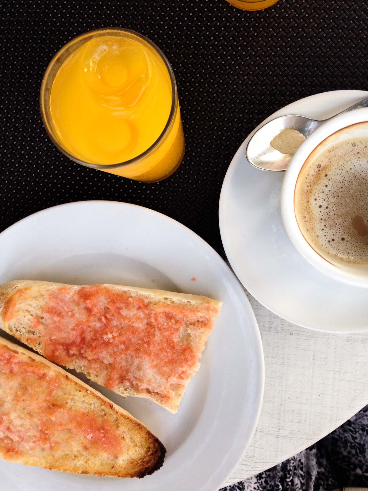 Flat lay picture of toast with tomate, juice, and coffee