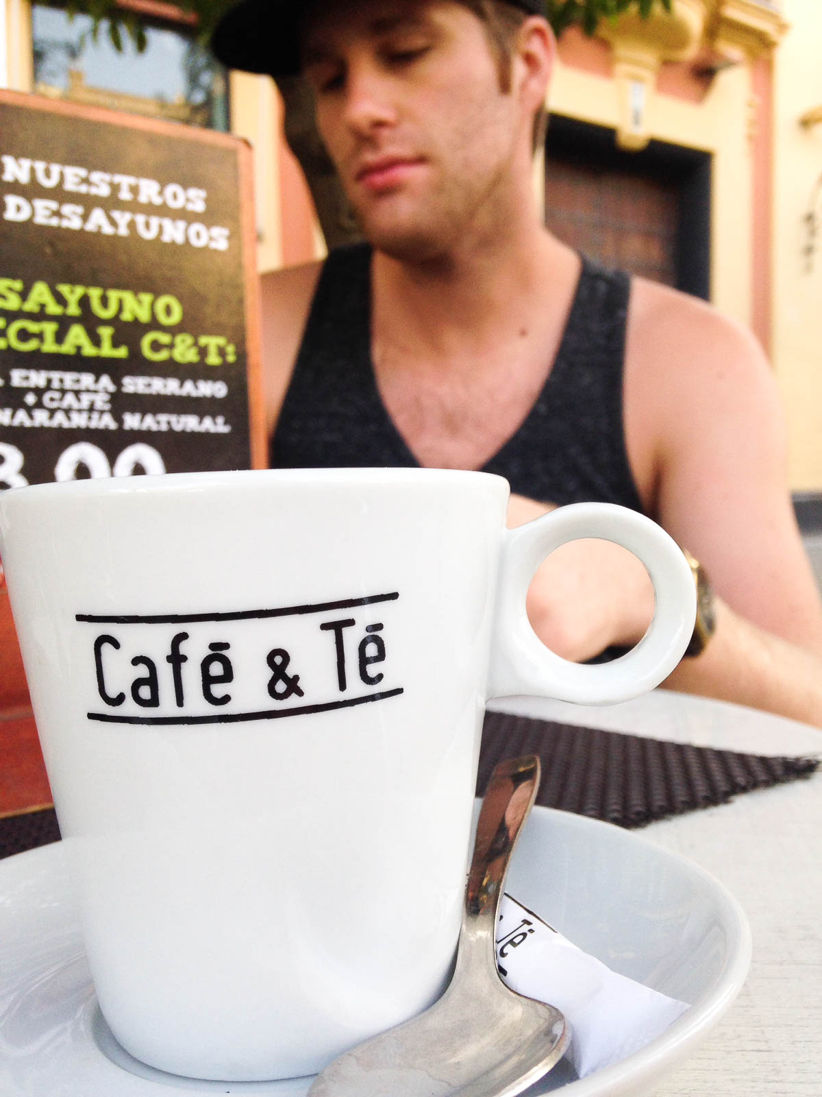 Close-up of a coffee mug with a man in the background